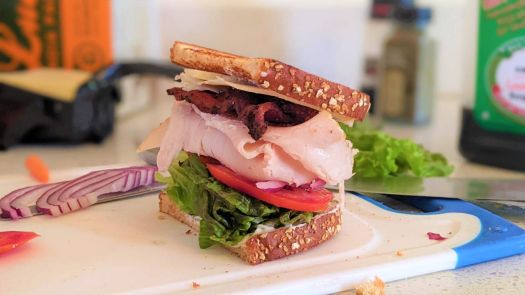 Just a little lunchtime halfer - Turkey, bacon, white cheddar, lettuce, tomato, onion, mayo on toast