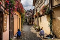 Local residents tending to their daily tasks in Eguisheim, France.