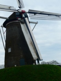 Mill in Amerongen. The miller is teaching a young man how to work with the mill!