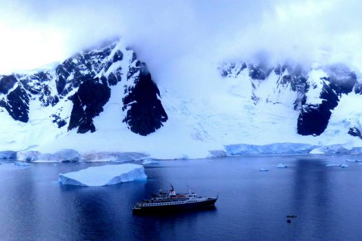 The Sea Adventure ship approaching icebergs in Antarctica