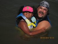 Papa teaching Marissa to swim