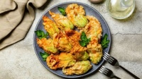 Head off too many zucchini this summer by stuffing blossoms with ricotta cheese, parsley and a pinch of cayenne, then dipping in flour selzer batter and frying in olive oil_