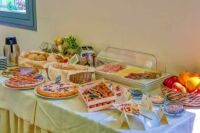 Pizza, walnuts, cheese, bread baskets, dessert pie, and fruit included in hotel buffet