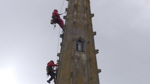 TWO STEEPLEJACKS CLIMBING CATHEDRAL SPIRE