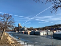 Vapor trails over Baypoint boathouses.