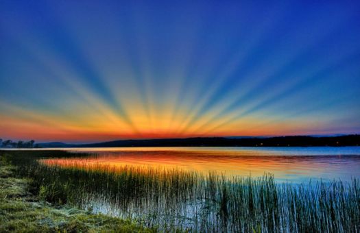 Anticrepuscular rays over lake