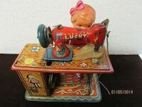 Toy Tin wind Up Girl & Her Lucky Brand Sewing Machine