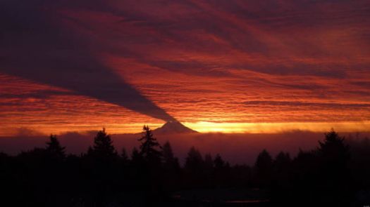 Mt. Ranier casts a shadow on the clouds