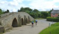 Cycling by the Packhorse Bridge.