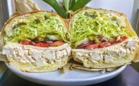 The Iva — House Spicy Cajun Sauce with Chicken Breast, Pepperjack, Lettuce, Tomatoes, Red Onions, Pickles, Pepperoncinis, Garlicky Aioli, Deli Mustard, Avocado