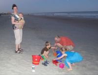 Family fun at the beach at dusk
