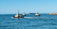 Tugboats getting into position