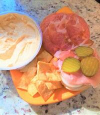 Snacks: spicy capicola, prosciutto, salami, Vermont cheddar, onion, pickle, dijon on an onion roll with hummus and pita chips