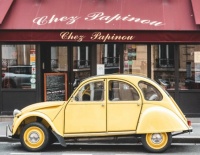 Yellow Citizen Taxi in front of Chez Papinou Restaurant