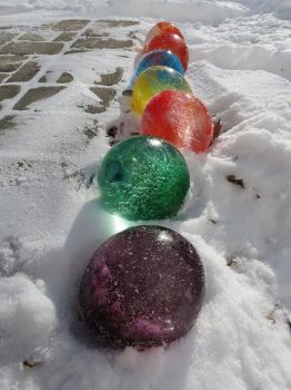 FROZEN BALLS, fill balloons with water and food coloring and freeze, take balloon off after frozen.