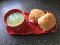 Red bowl, green soup, brown rolls