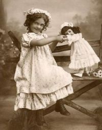 Vintage Photo Of A Girl And Her Doll Posing For The Camera