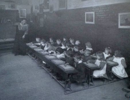 Old photo of school children, they were only allowed to write with their right hands