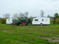 The first caravans are being pulled, per tractor, from the campingsite, to where the cars wait.....