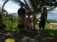 Family waiting at roadside in Alatau New Guinea