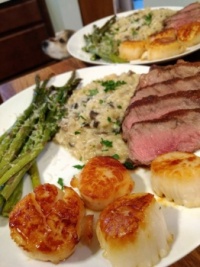 Steak, scallops, mushroom risotto, and asparagus - the Beagle has a bite of steak on her nose