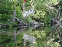 sign along the Saranac River (canoe waves? really)