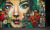 Bikes lean against wall painting