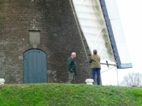 Mill in Amerongen. The miller is teaching a young man how to work with the mill!