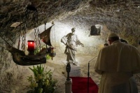 The Pope praying at St Paul's grotto.