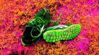 Green soccer shoes on pink & orange grass . .