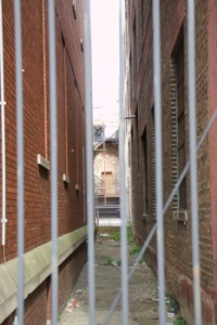 Alleyway behind fence