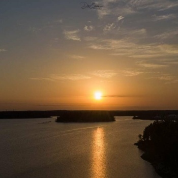 Solve Sandy Bay, Saskatchewan: Aerial Sunset Over Serene Lake Jigsaw 