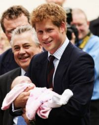 Prince Harry with a baby