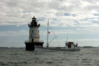 Hooper lighthouse with Winnie Estelle fishing boat passing by