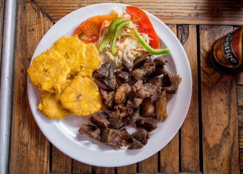 Solve Griot haïtien served with bannann peze and pikliz, with Prestige ...