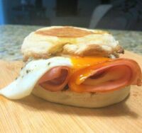 Brie wrapped in ham and baked, then put on toasted English muffin with sunny sider