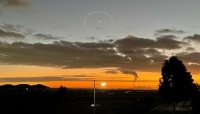 Newport power station chimney at sunrise, with UFO