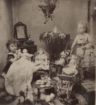 Vintage Photo of Two Children With More Dolls Than They Need