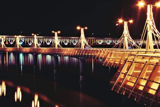 Lighted bridge over the river and pier