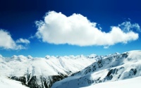 Clouds above snowy mountains