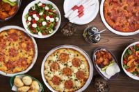 From Meat Lovers' to Cheese Lovers' Pizzas, with Wings and Dip, Dinner Rolls and Meat-Laden Salad