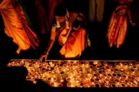 Devotee lights an oil lamp at 2022 Diwali ceremony in Colombo, Sri Lanka