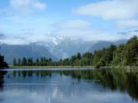 NZ Lake Matheson with Mt Cook behind the clouds 