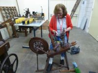 Textile museum Winterswijk.   Working on an old spinning wheel