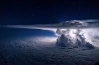 A developing thunderstorm climbs high into the atmosphere over the Pacific Ocean south of Panama