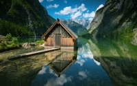 Small Fishing Cabin in the middle of a lake between mountains