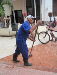 Man sweeping street