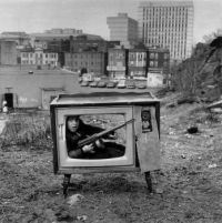 Boy hiding in a TV set. Boston, 1972 by Arthur Tress