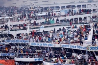 People board passenger ferries to travel home to celebrate Eid al-Fitr. Photo taken at the Sadarghat Launch Terminal in Dhaka, Bangladesh