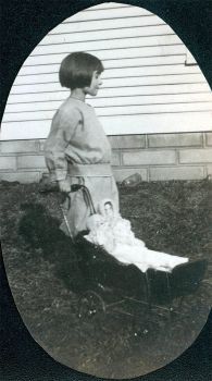 Vintage Photo of 1920 era Child With Doll And Carriage
